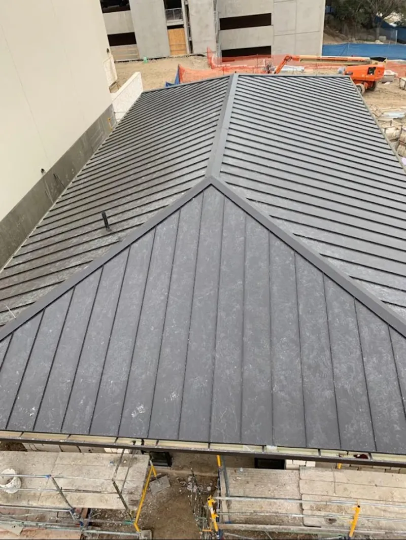 Commercial metal roof construction with crane equipment in Galena Park