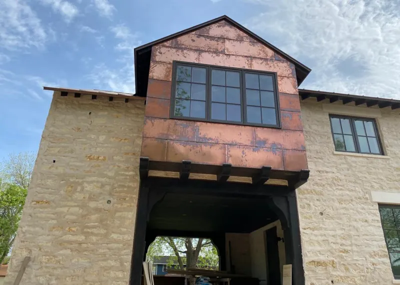 Copper metal panel facade on a stone building for Roof Repair in Galena Park