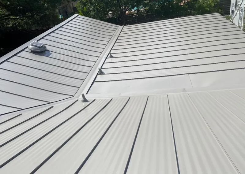 Solar attic fan installed on a metal roof for Roof Ventilation in Galena Park